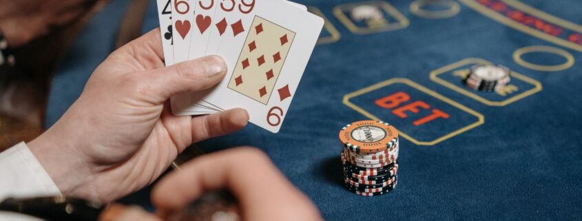 Close Up Of A Card Hand Playing Baccarat